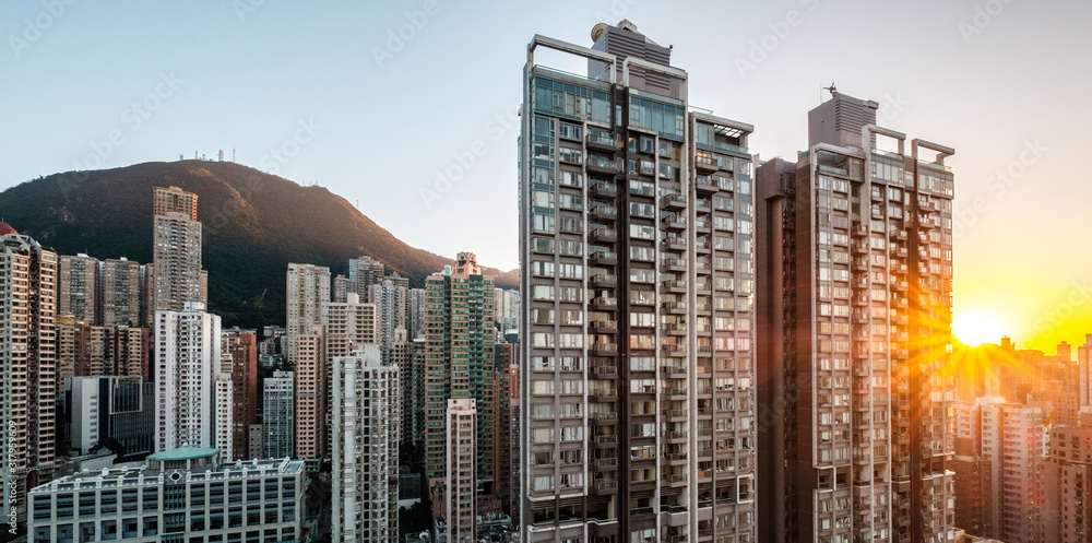 sunsert sky over modern city skyline with residential skyscraper buildings in Hong Kong