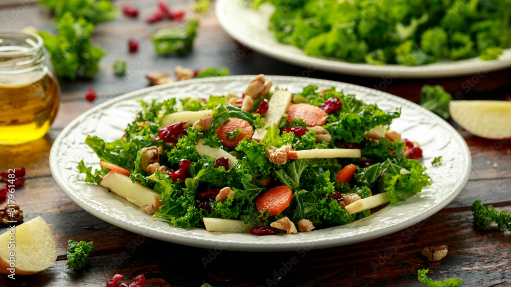 Kale salad with dried cranberry, carrots, walnuts and apple. healthy vegan food. Kale salad with dried cranberry, carrots, walnuts and apple. healthy vegan food.