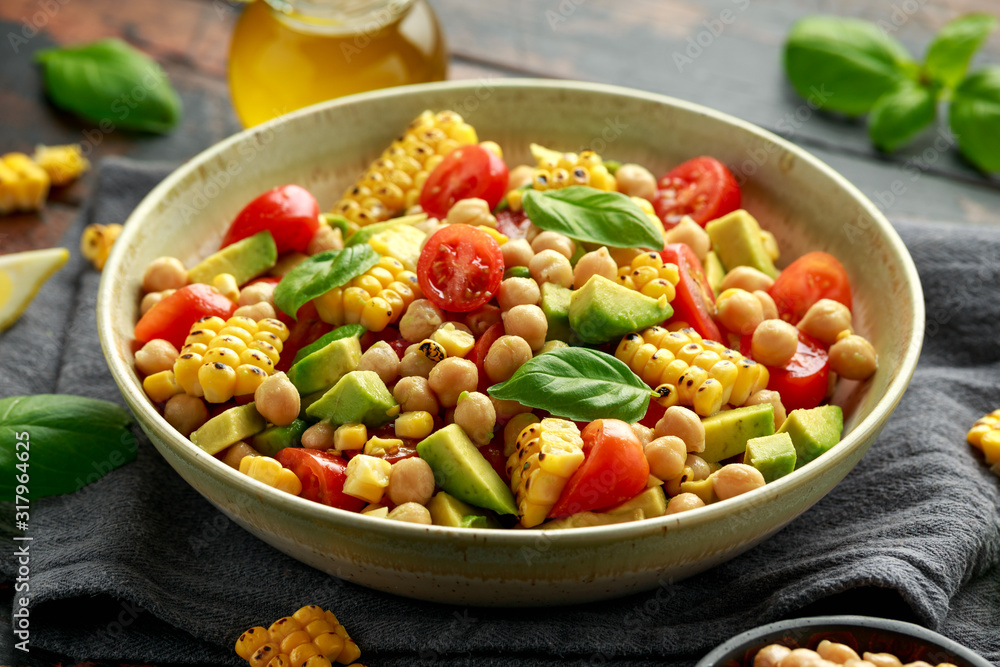 Avocado chickpea salad with grilled sweet corn, tomato and basil. Healthy vegan food Avocado chickpea salad with grilled sweet corn, tomato and basil. Healthy vegan food