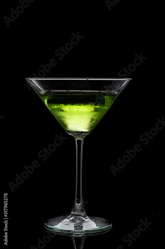 martini glass and splash from falling ice on a black background