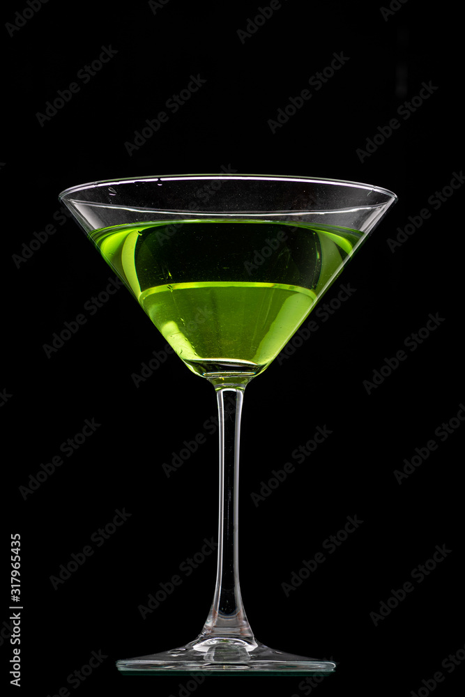 martini glass and splash from falling ice on a black background