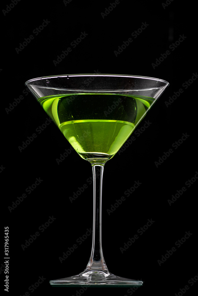 martini glass and splash from falling ice on a black background martini glass and splash from falling ice on a black background