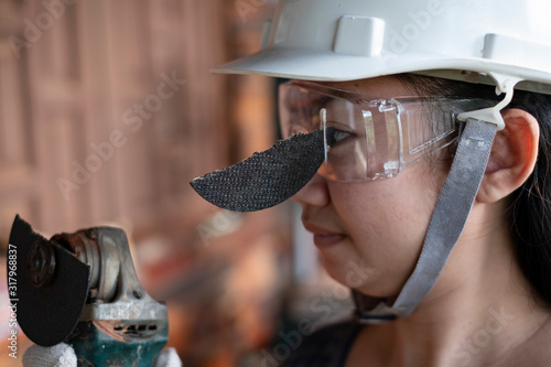 Wear safety glasses saved this engineer women is eye while work because plug in cutting disc broken, Dangers of using power tools, Safety first. photo