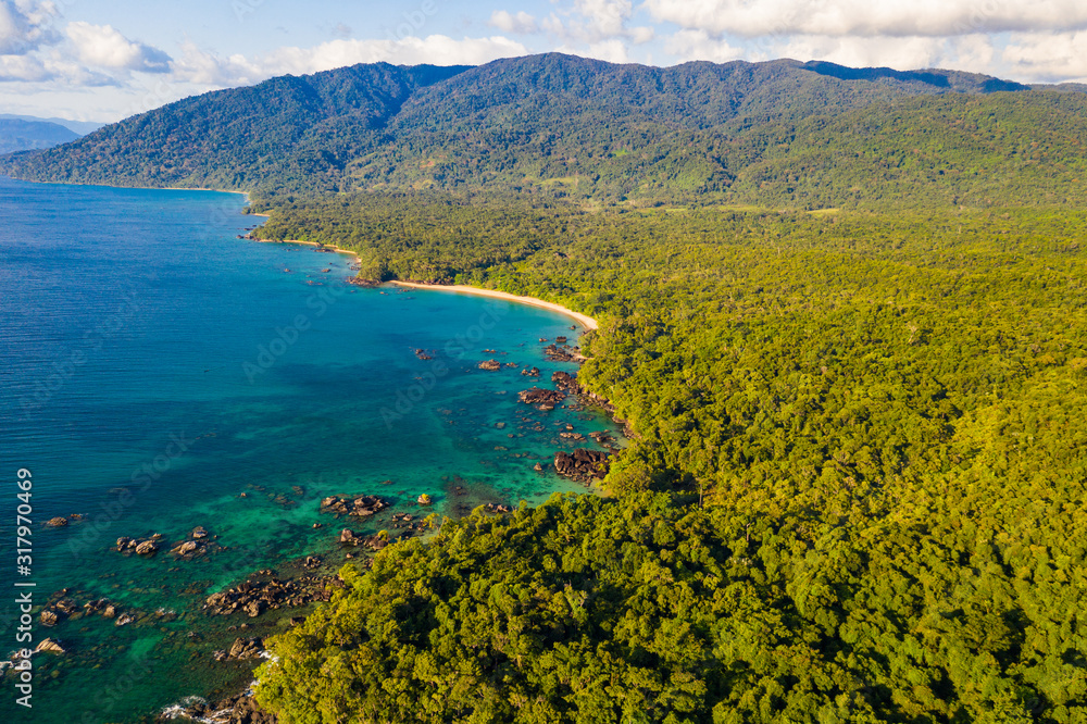 Aerial view of remote beach squeezed between coral reef and primary rainforest, Tampolo, Masoala National Parl, Madagascar