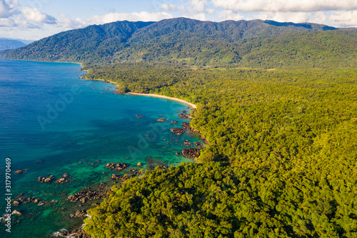 Aerial view of remote beach squeezed between coral reef and primary rainforest, Tampolo, Masoala National Parl, Madagascar photo