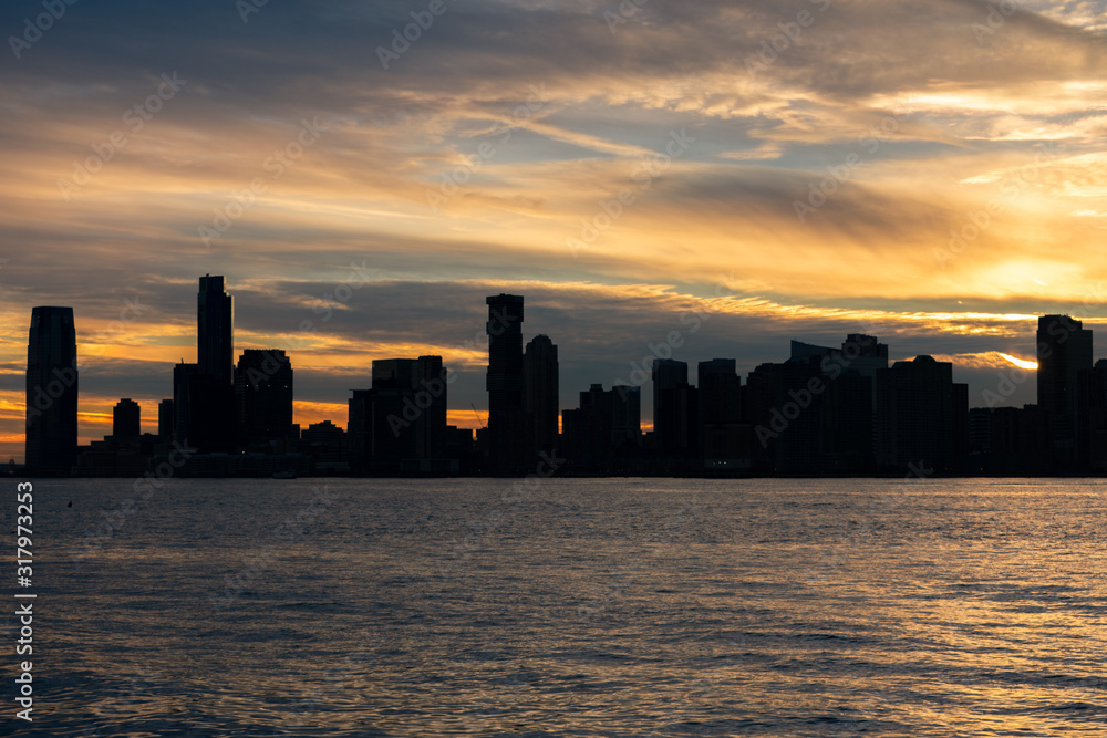 Silhouette of the Jersey City Skyline along the Hudson River during a Beautiful Sunset