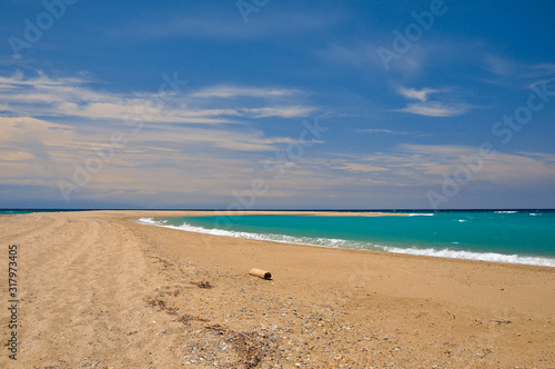 Sandy beach on the azure sea coast