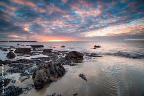 Dramatic sunset over the beach at Llandanwg near Barmouth on the north coast of Wales photo