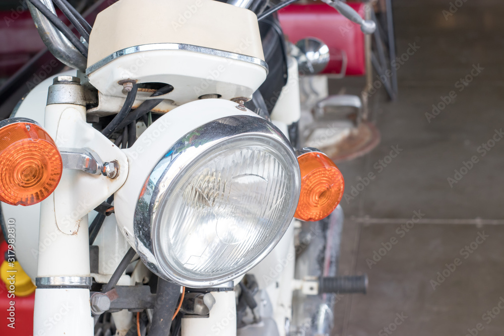 Circular headlights and turning lights of old white motorcycles Circular headlights and turning lights of old white motorcycles