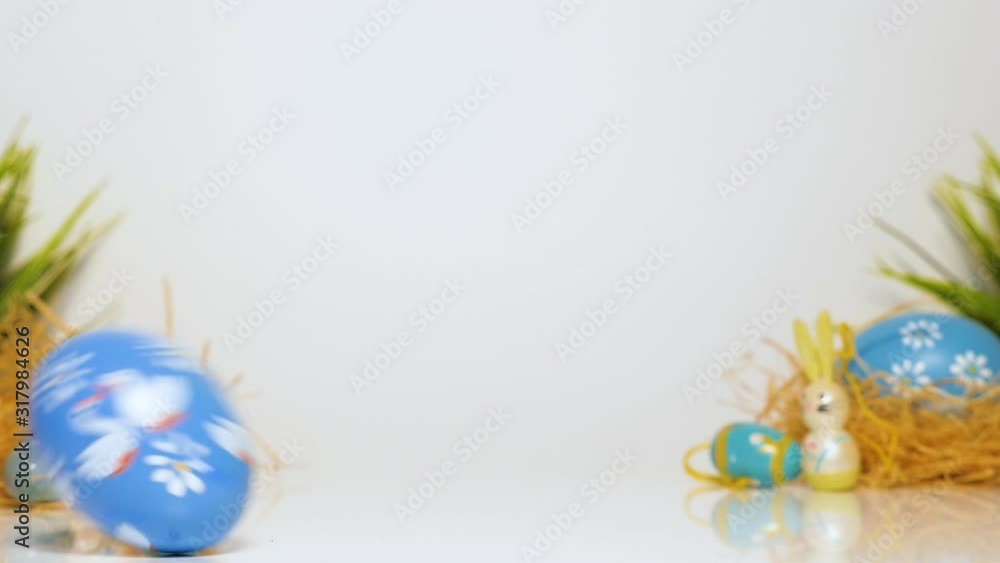 Easter eggs roll on the table, white background, loopable Easter eggs roll on the table, white background, loopable
