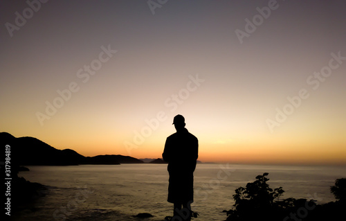silhouette on the beach. boy and sea at sunset