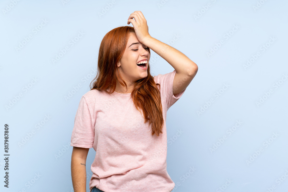 Teenager redhead girl over isolated blue background has realized something and intending the solution Teenager redhead girl over isolated blue background has realized something and intending the solution