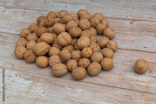 Whole walnuts on rustic old wooden table