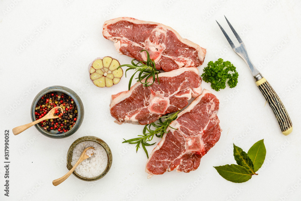 Lamb meat on stone tray on white concrete background