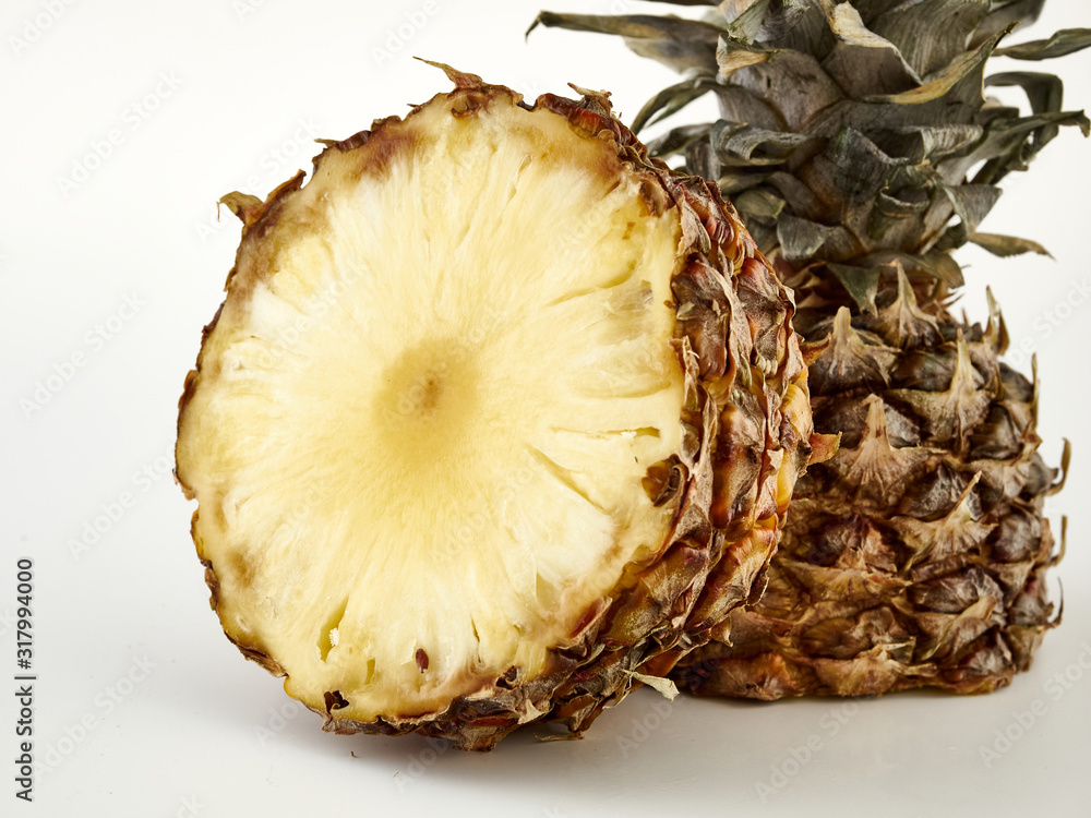 Delicious ripe Pineapple and its slices on a white background.Isolate Delicious ripe Pineapple and its slices on a white background.Isolate