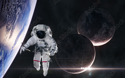 Fototapeta Naklejka Na Ścianę i Meble -  Astronaut in orbit of planet in deep space. Rising star. Science fiction. Elements of this image furnished by NASA