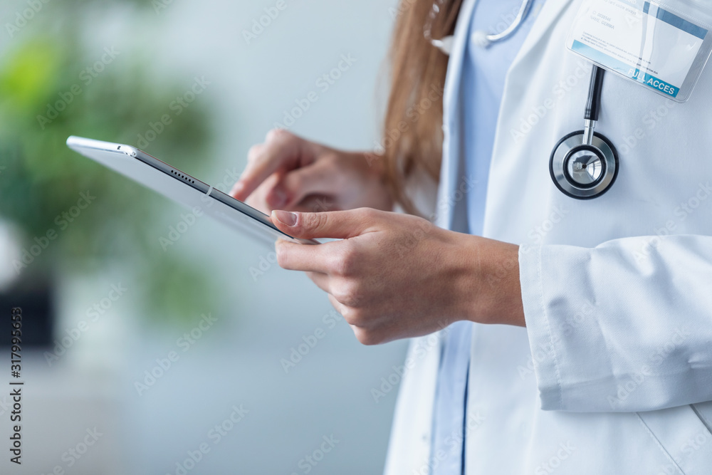Female doctor using her digital tablet in the office. Female doctor using her digital tablet in the office.