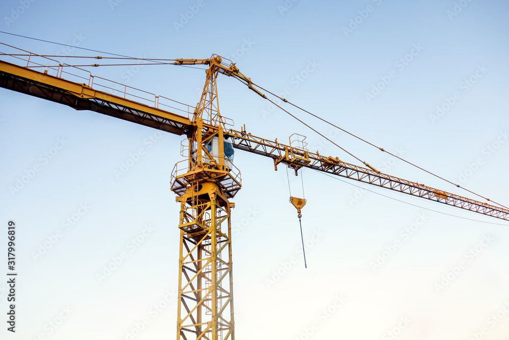 yellow crane with blue sky as background