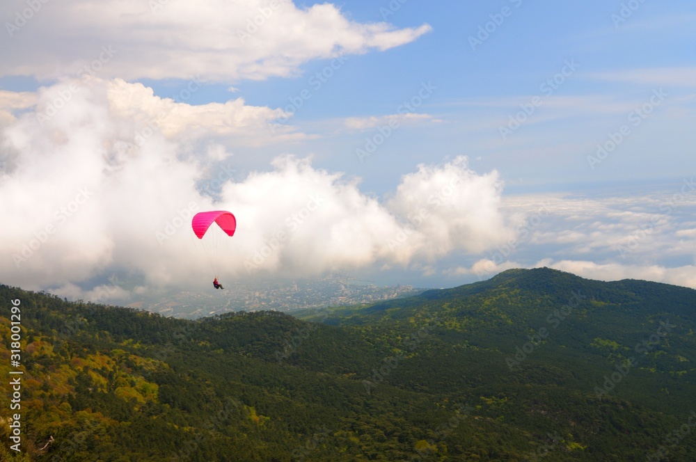Skydiver flies over the mountains Skydiver flies over the mountains