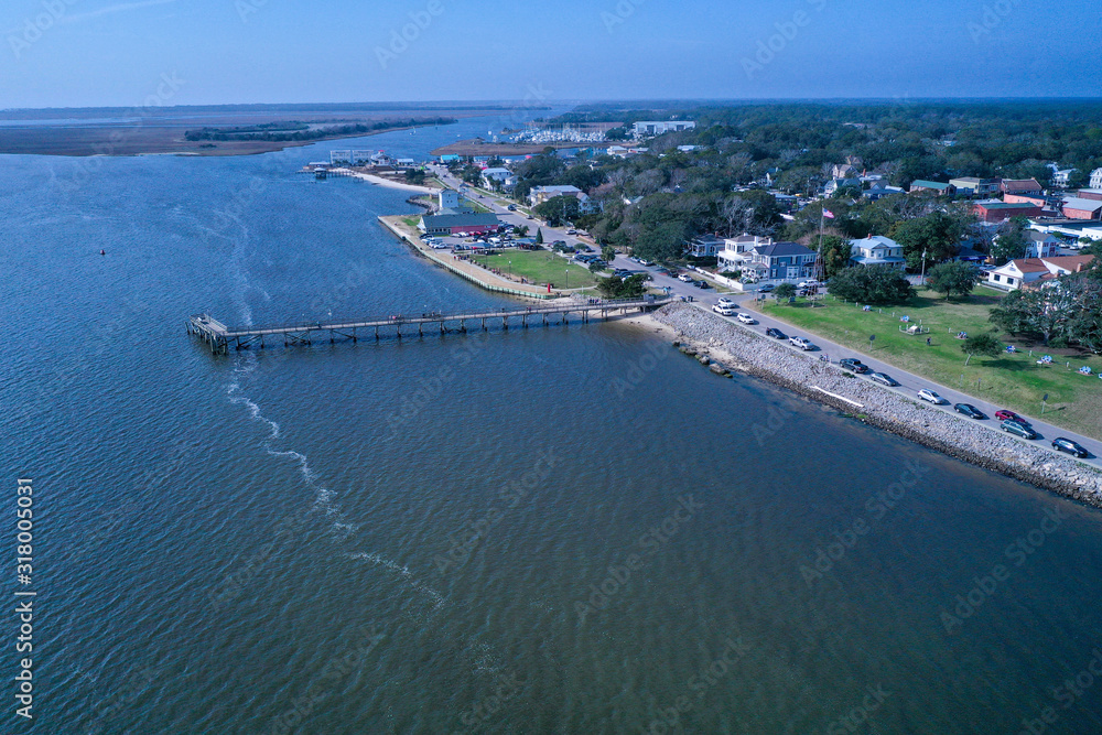 Wide aerial view of downtown Southport NC. From over the water looking back at the town and river front. The pier is also visible.