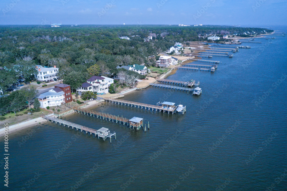 Aerial view looking at the docks along the waterfront at Southport NC. The string of boat docks line the Cape Fear river opening.