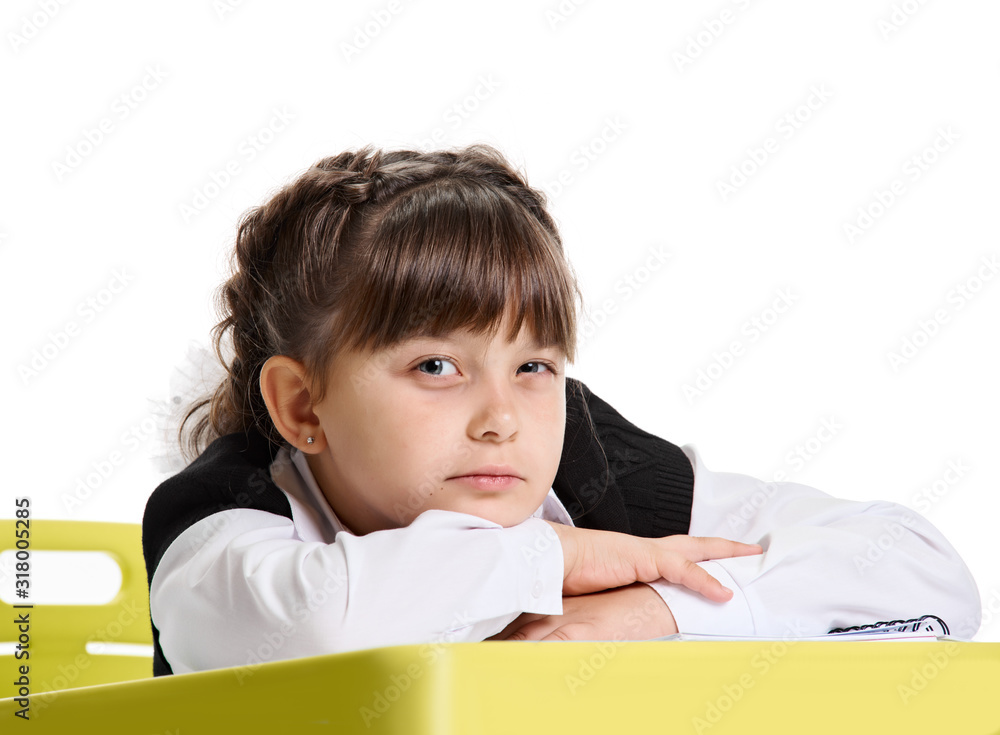 Pretty tired girl in school uniform lying at the desk Pretty tired girl in school uniform lying at the desk