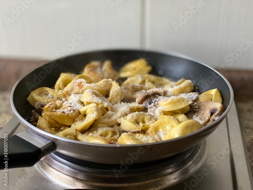 ravioli with mushrooms in a pan