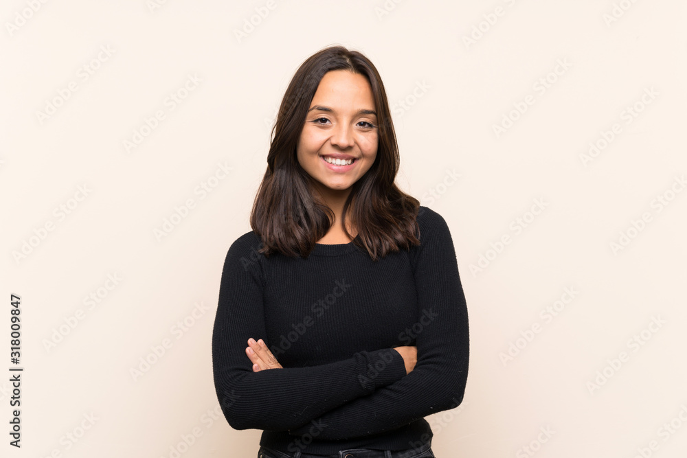 Young brunette woman with white sweater over isolated background keeping the arms crossed in frontal position Young brunette woman with white sweater over isolated background keeping the arms crossed in frontal position