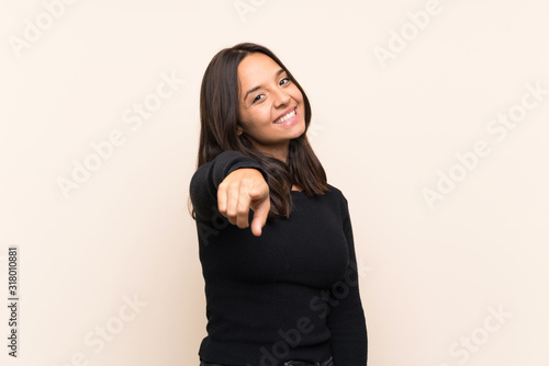 Young brunette woman with white sweater over isolated background points finger at you with a confident expression © luismolinero