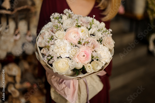 Close-up of holiday bouquet in woman s hands