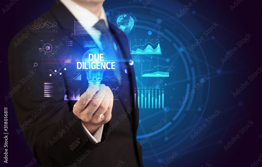 Businessman holding lightbulb with DUE DILIGENCE inscription, Business idea concept Businessman holding lightbulb with DUE DILIGENCE inscription, Business idea concept