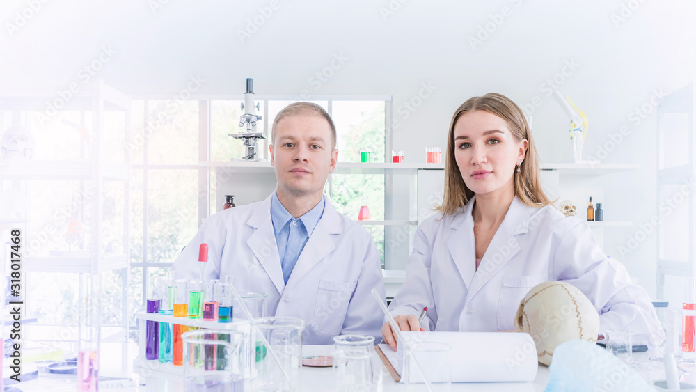 Two scientists working in chemical laboratory