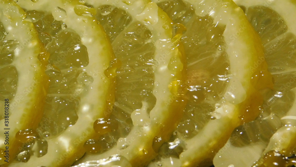 water drops over lemon slices on a black background close-up water drops over lemon slices on a black background close-up