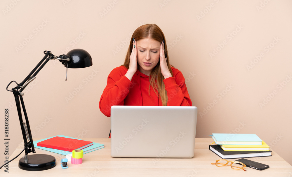 Young student woman in a workplace with a laptop with headache Young student woman in a workplace with a laptop with headache