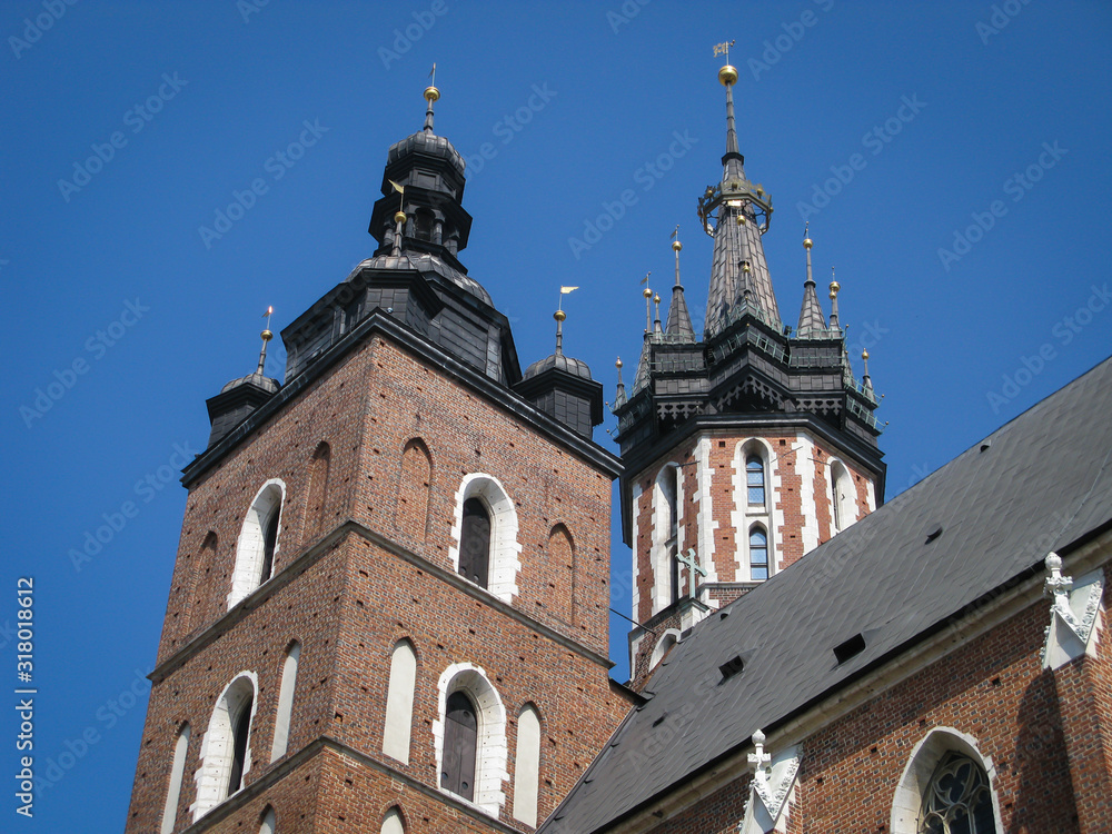 bottom view of the towers of the St. Mary's Basilica on a background of blue sky, Krakow, Poland