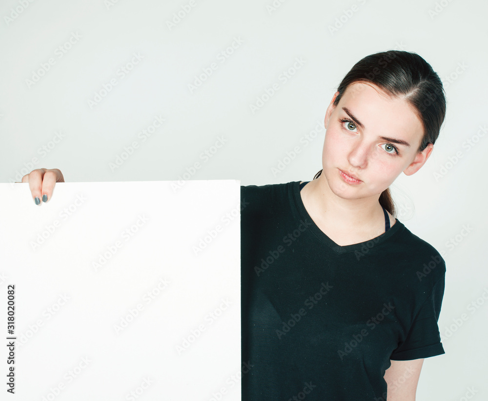 young pretty brunette girl with placard on white background wearing business costume student, lifestyle people concept young pretty brunette girl with placard on white background wearing business costume student, lifestyle people concept