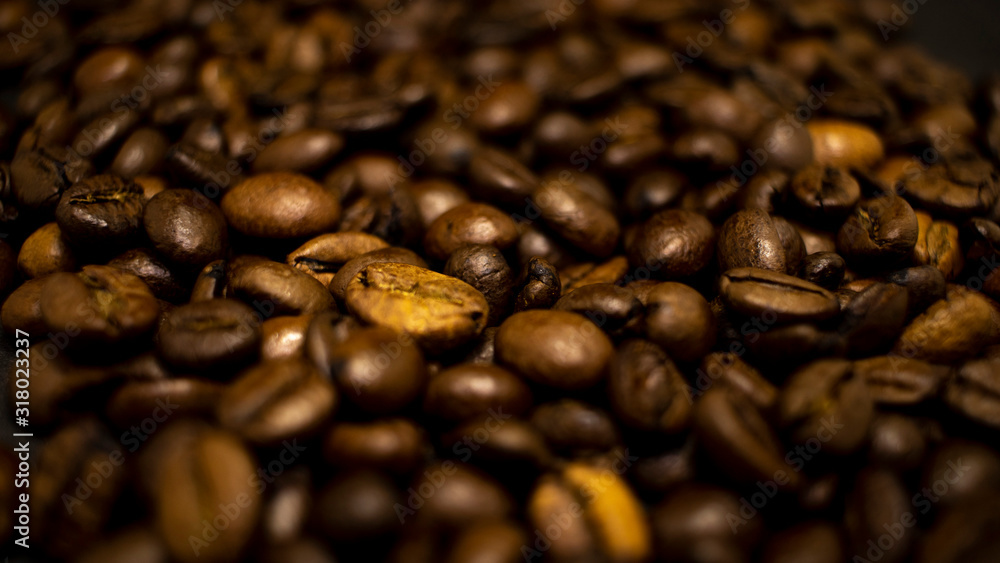 Dark background and texture of coffee beans, selective focus, closeup grains. Dark background and texture of coffee beans, selective focus, closeup grains.
