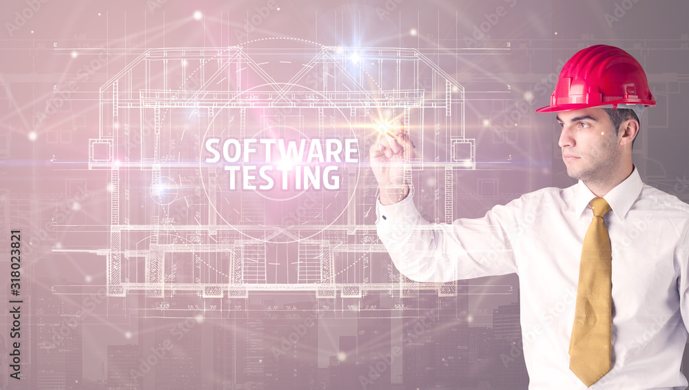 Handsome architect with helmet drawing SOFTWARE TESTING inscription, new technology concept Handsome architect with helmet drawing SOFTWARE TESTING inscription, new technology concept