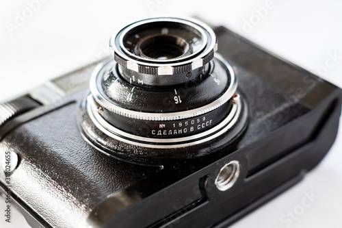 Retro old film photo camera. On white background