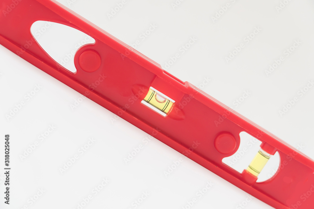 Red level tool used for determinig the level of a surface for construction . Red level tool used for determinig the level of a surface for construction .