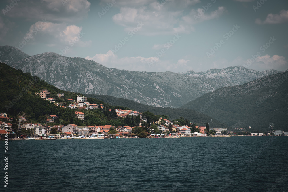 Fragment of the Bay of Kotor with houses on shore, Montenegro. Vintage toning