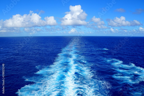 A view of beautiful blue ocean and waves from behind a ship © K.A