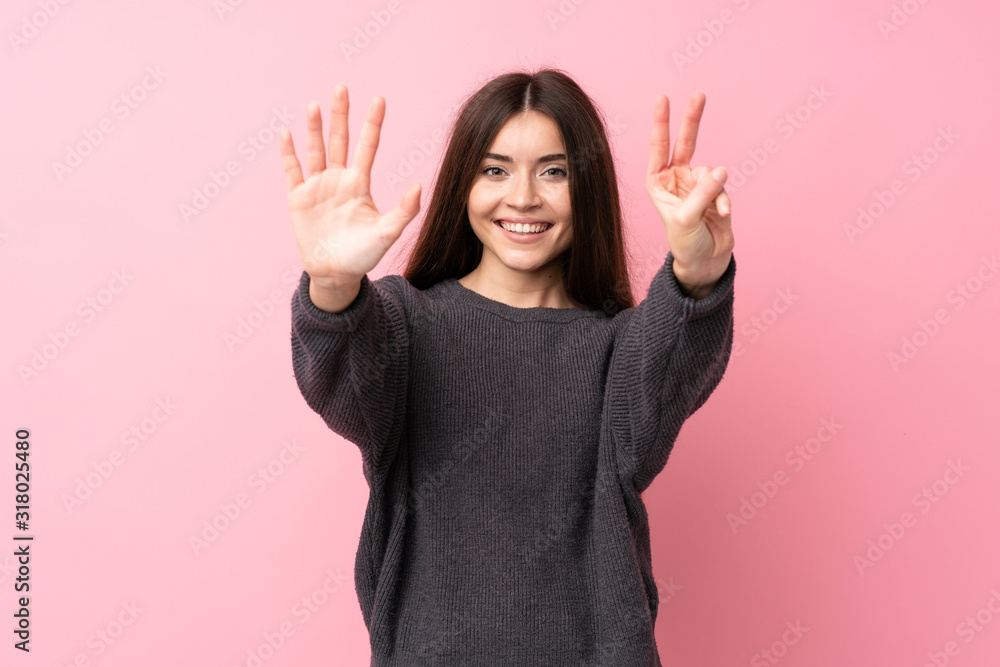 Young woman over isolated pink background counting seven with fingers Young woman over isolated pink background counting seven with fingers
