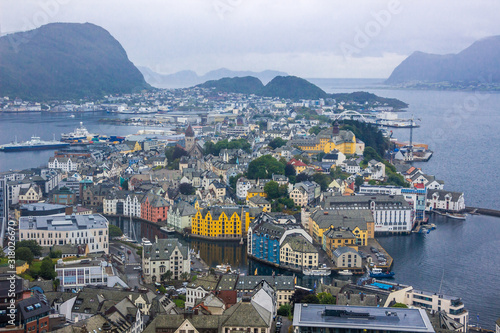 clouds over the harbor and the waterfront buildings in Alesund