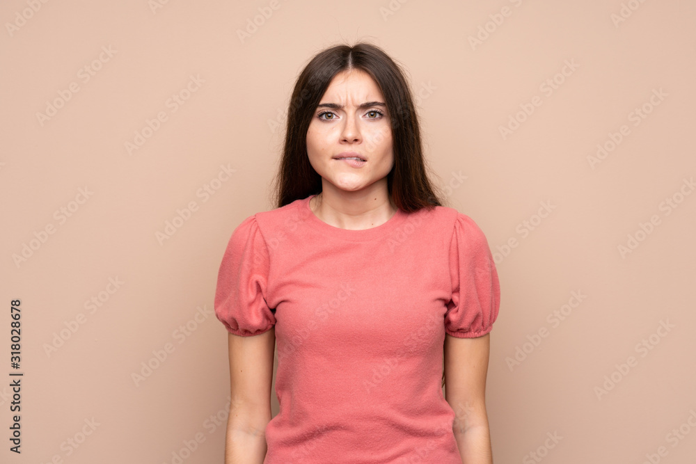 Young woman over isolated background having doubts and with confuse face expression Young woman over isolated background having doubts and with confuse face expression