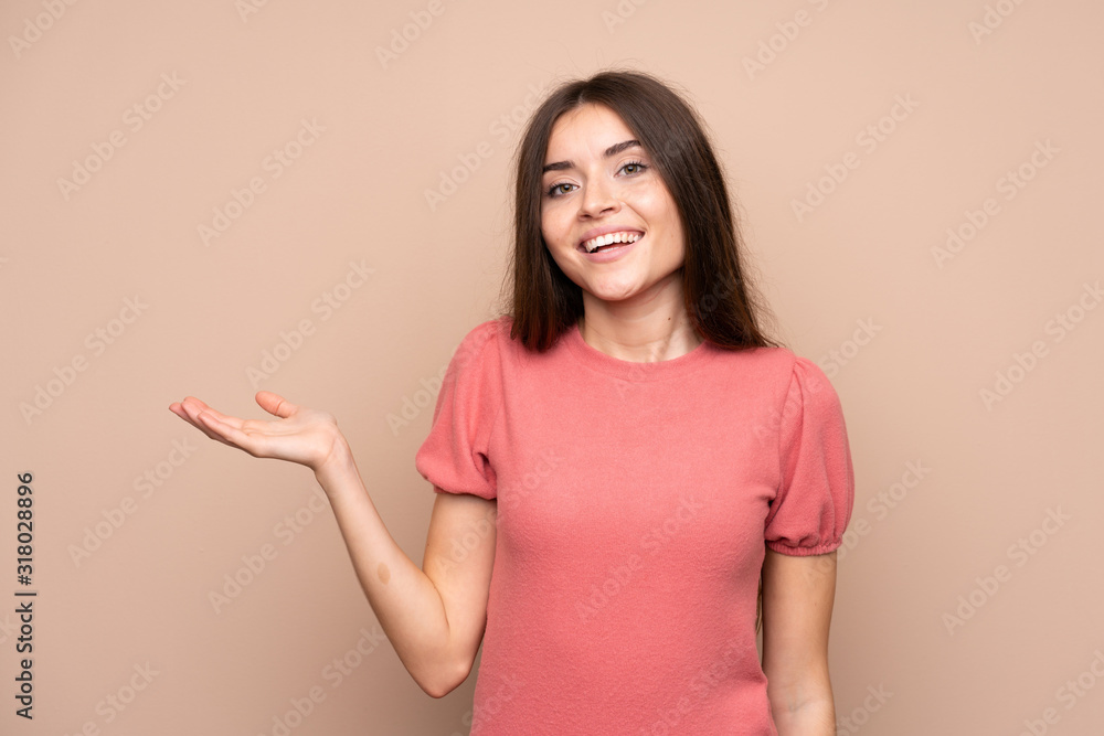 Young woman over isolated background holding copyspace imaginary on the palm Young woman over isolated background holding copyspace imaginary on the palm