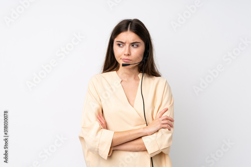 Young telemarketer woman over isolated white background thinking an idea © luismolinero