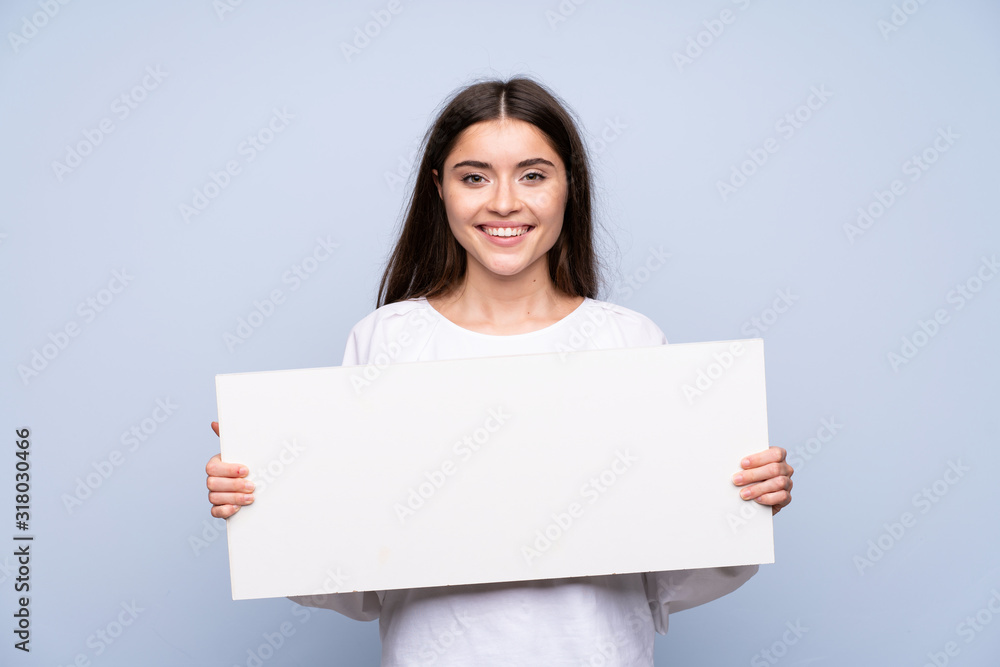 Young woman over isolated blue background holding an empty white placard for insert a concept Young woman over isolated blue background holding an empty white placard for insert a concept