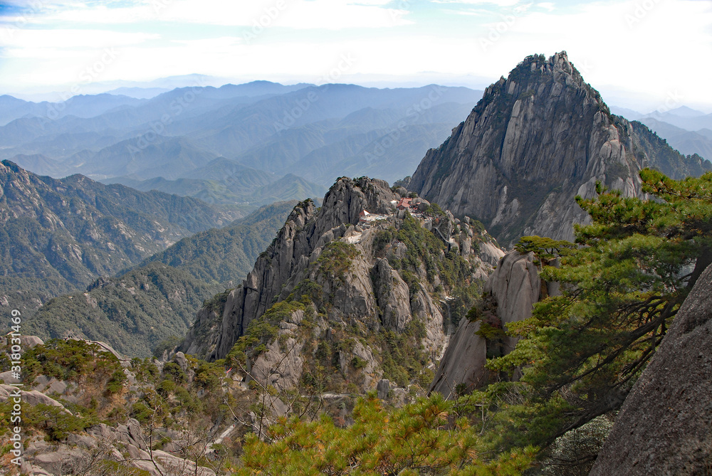 Fototapeta premium Huangshan Mountain in Anhui Province, China. View of Yuping Hotel and Celestial Capital Peak on the path to Lotus Peak the highest point of Huangshan. Scenic view on Huangshan Mountain, China.