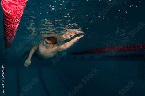 male athlete in a swimming competition swims in the pool. scuba diving, swimmer goggles for swimming and swimming